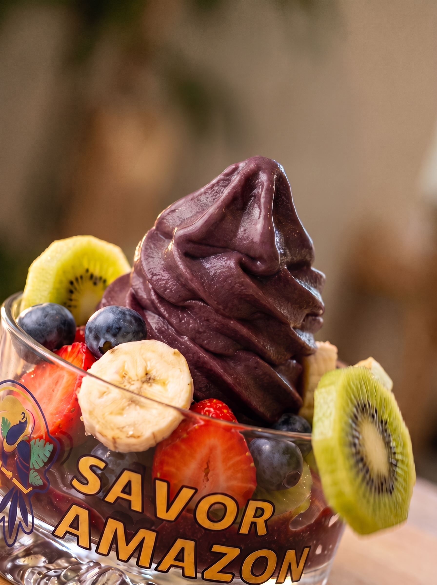Savor açaí bowl topped with banana, strawberry, kiwi and blueberries.